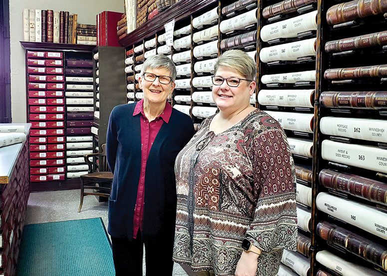 Jayne Schultz (l) and Lisa Grinna (r) are proud of the progress they have made in ensuring the historical records of Winneshiek County are forever preserved and accessible online. Records are available from 1850-1920 and 1970 to present day. Work continues to bridge the final 50 years’ records.